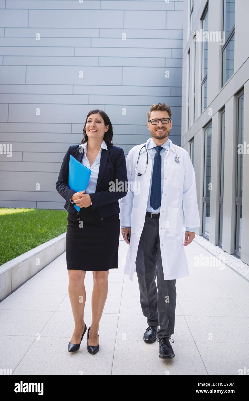 Doctors walking together in hospital premises Stock Photo