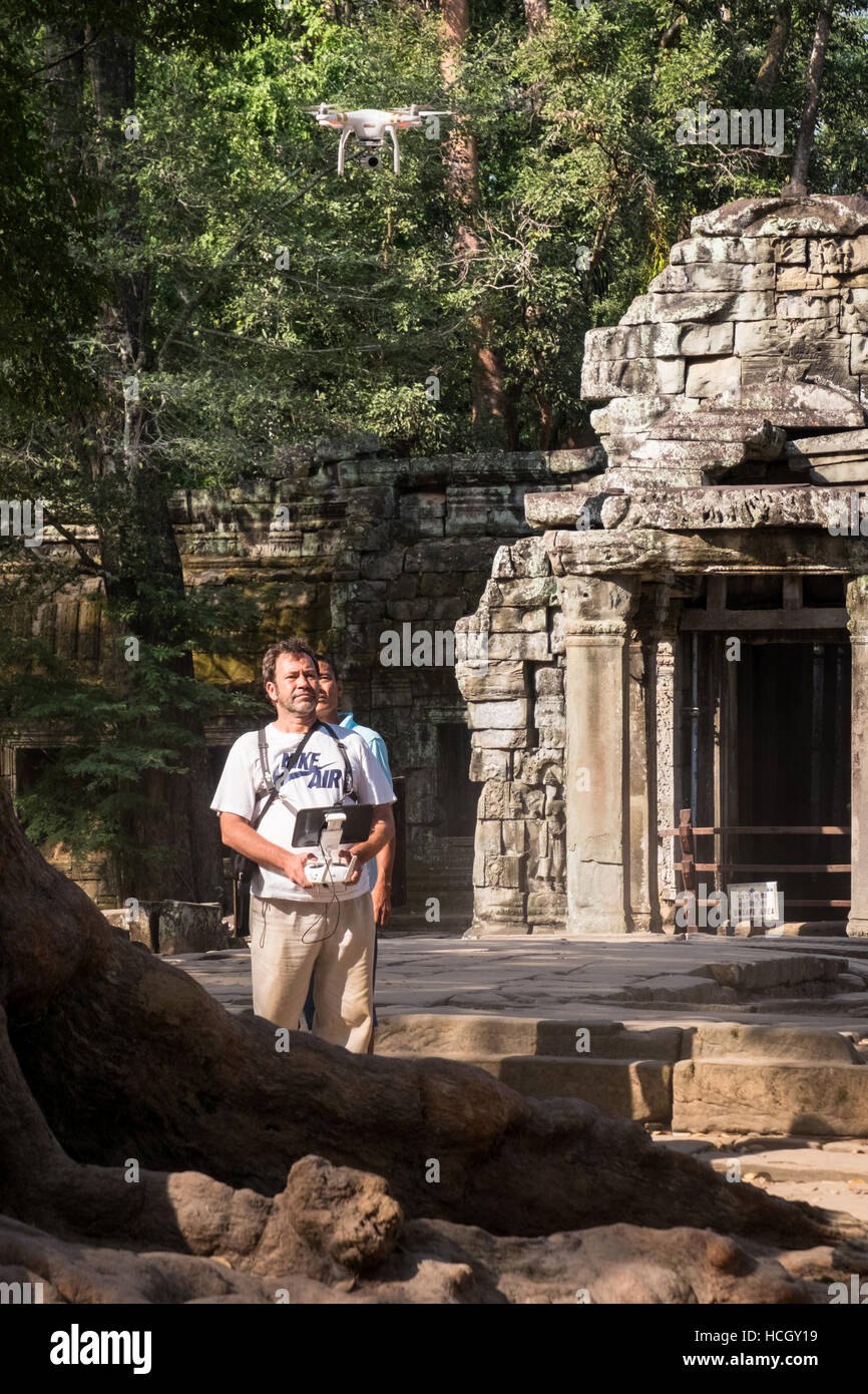 A western male tourist flying a drone at the Ta Prohm temple in Siem Reap, Cambodia. Stock Photo