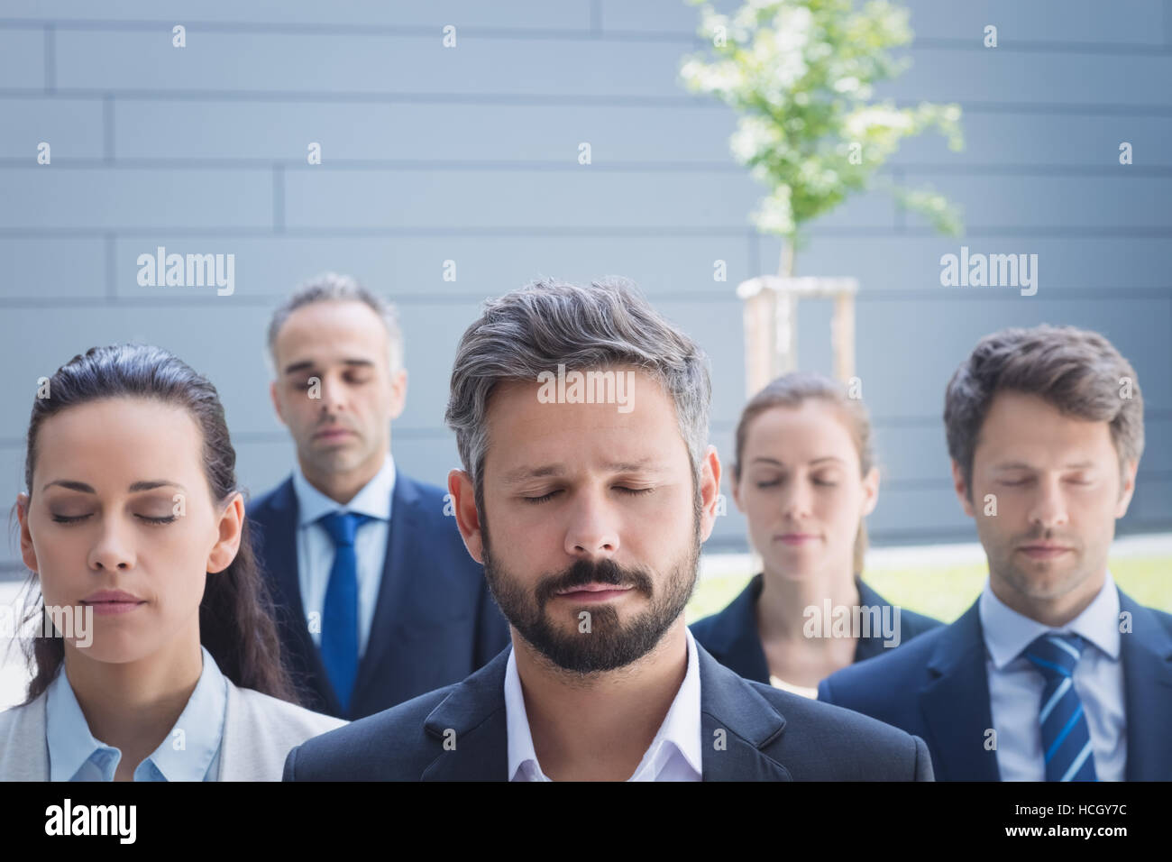 Group of business people with eyes closed Stock Photo