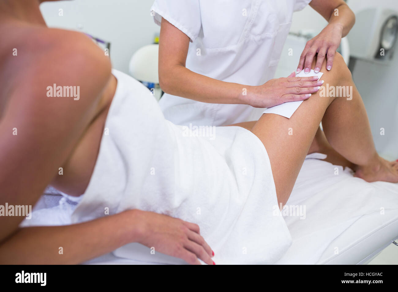 Woman getting her leg hair removed Stock Photo