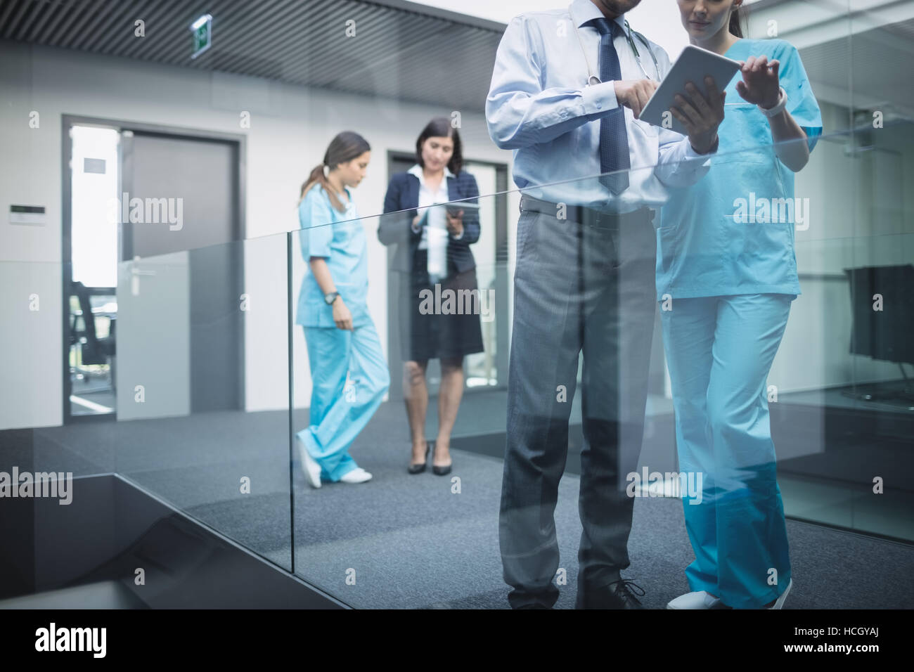 Doctors and nurses discussing over digital tablet Stock Photo
