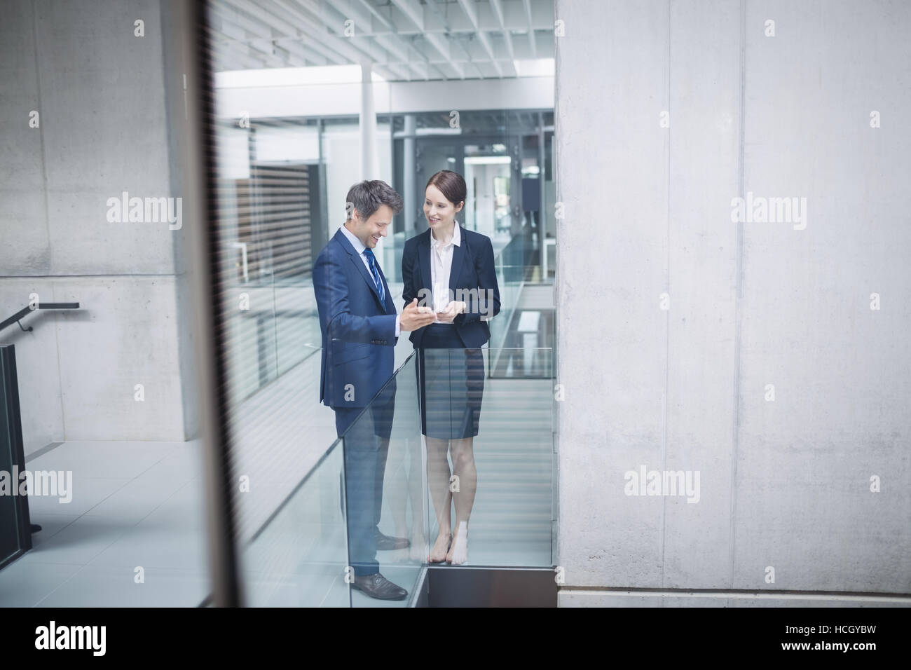 Businessman and colleague discussing over digital tablet Stock Photo