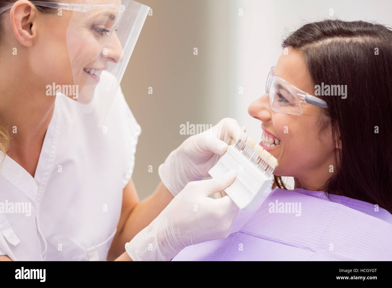 Dermatologist and female patient discussing on digital tablet Stock Photo