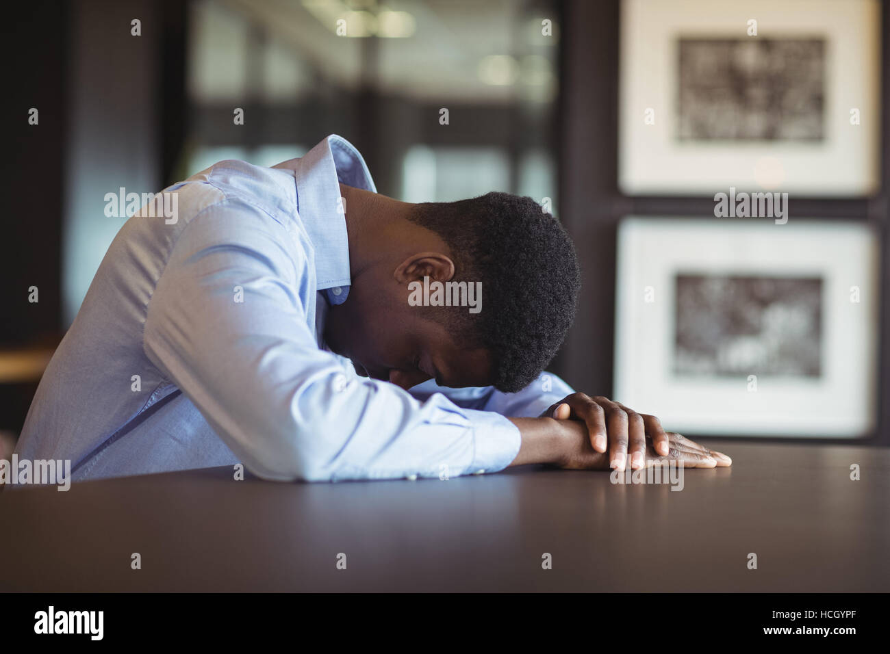 Stressed businessman sitting at his desk Stock Photo