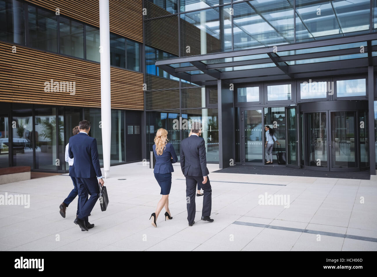 Business people entering in to an office building Stock Photo