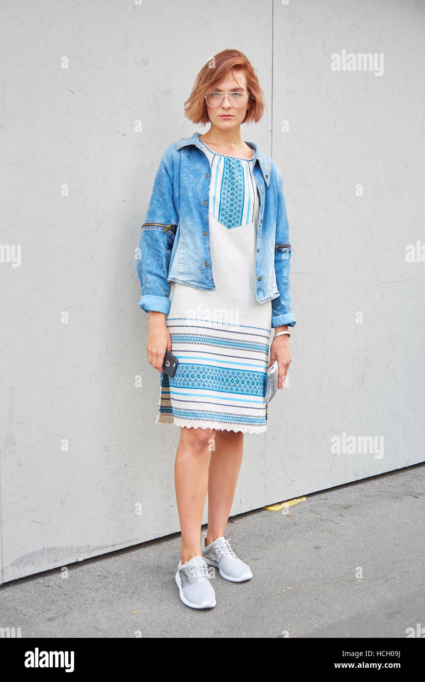Woman with jeans jacket and white and blue dress before Max Mara fashion show, Milan Fashion Week street style on September 22. Stock Photo