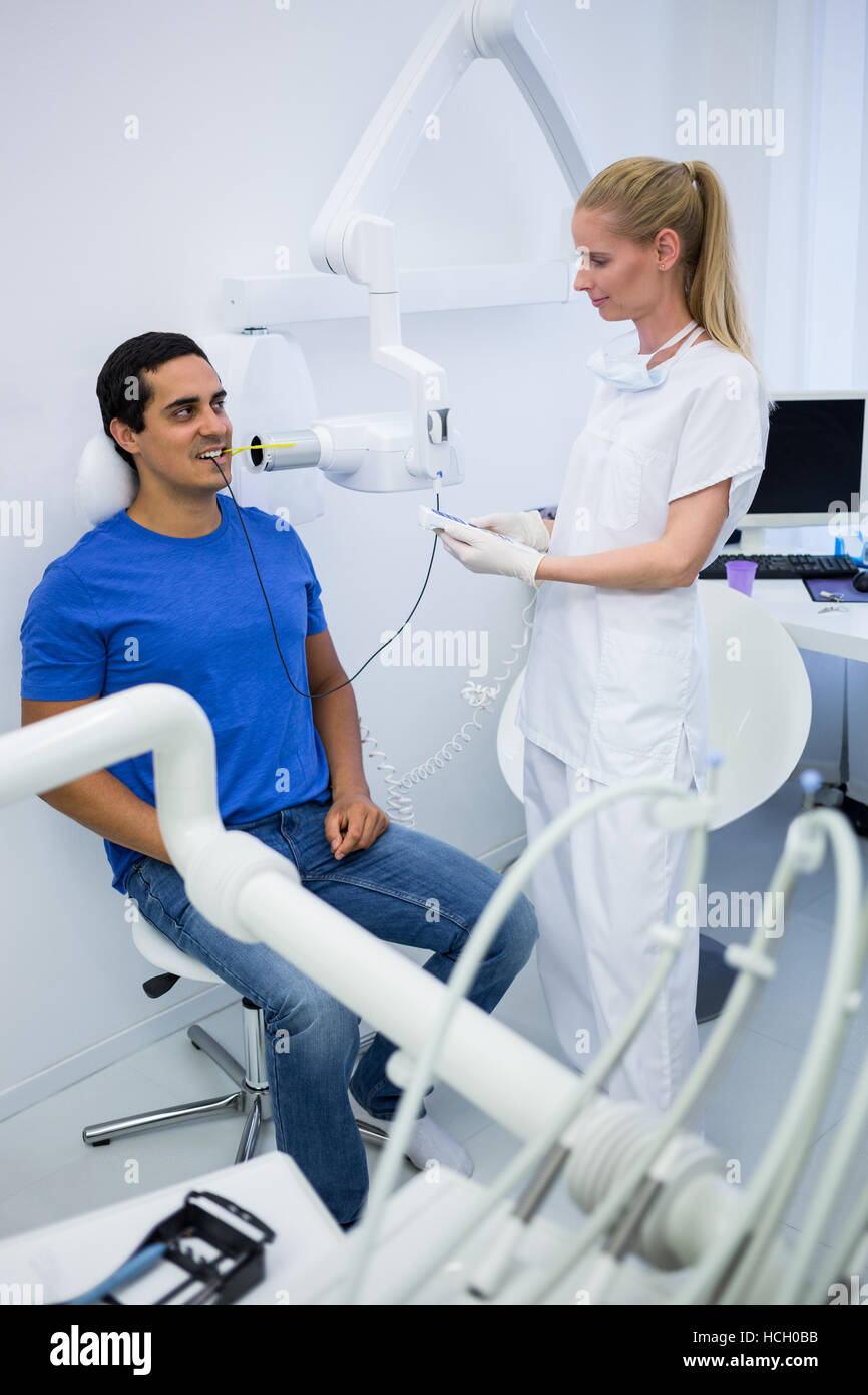Female dentist taking xray of patients teeth Stock Photo Alamy