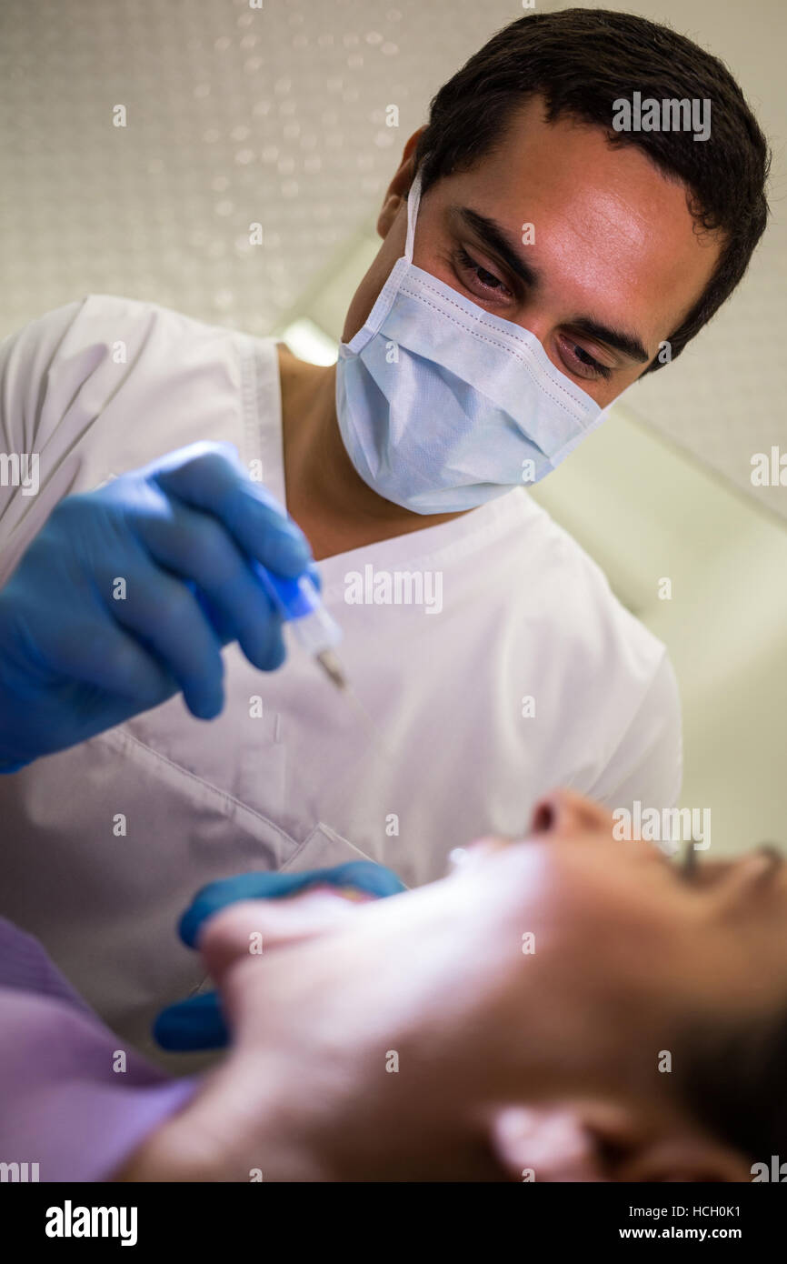 Dentist giving injection to the female patient Stock Photo Alamy