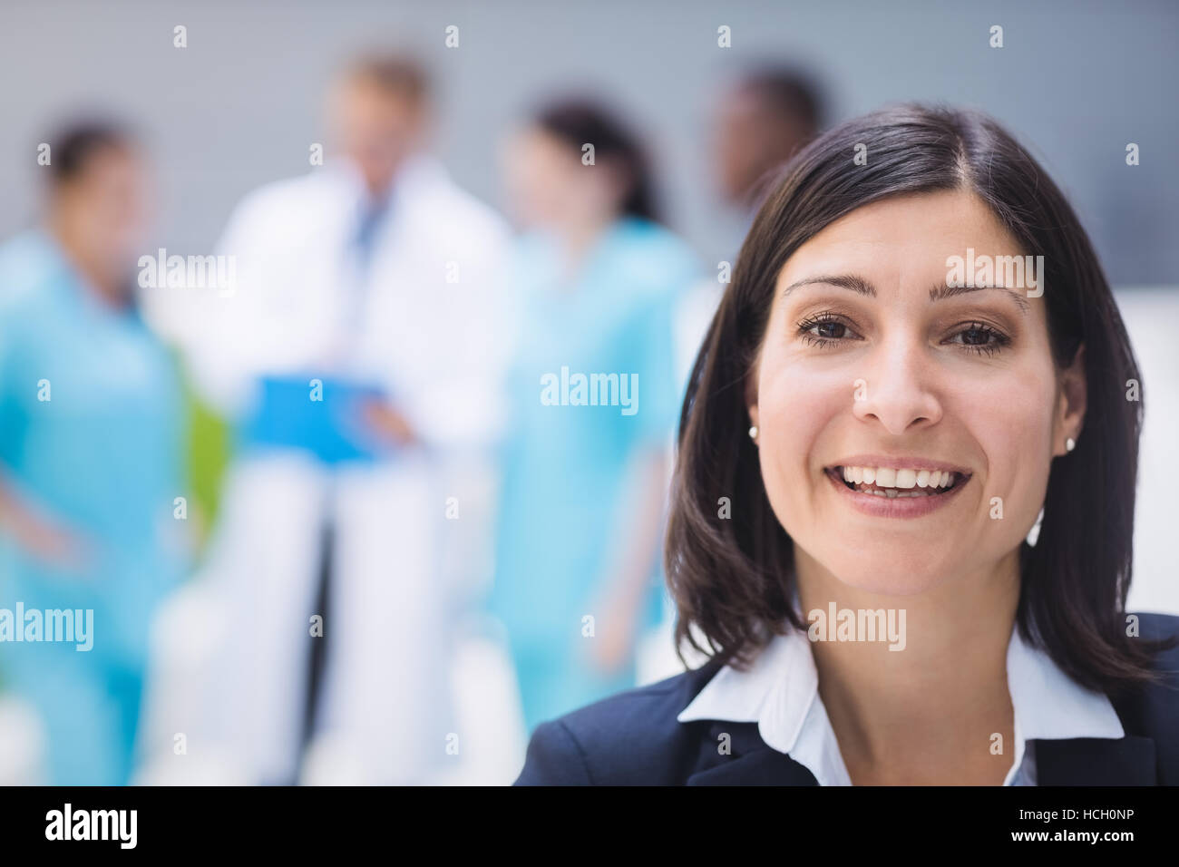 Smiling female doctor in hospital premises Stock Photo