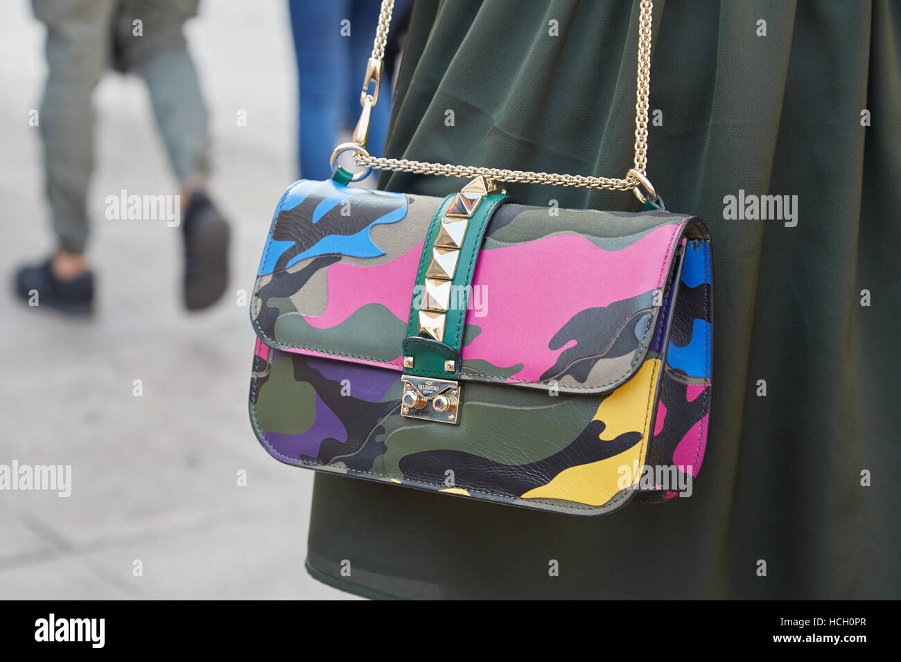 Woman with Valentino Garavani colorful camouflage bag before Cristiano fashion show, Milan Fashion Week street style Stock Photo - Alamy