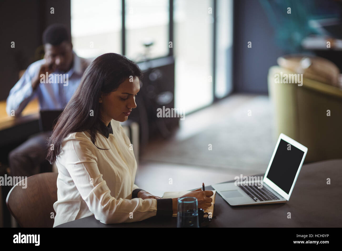 Businesswoman working at her desk Stock Photo