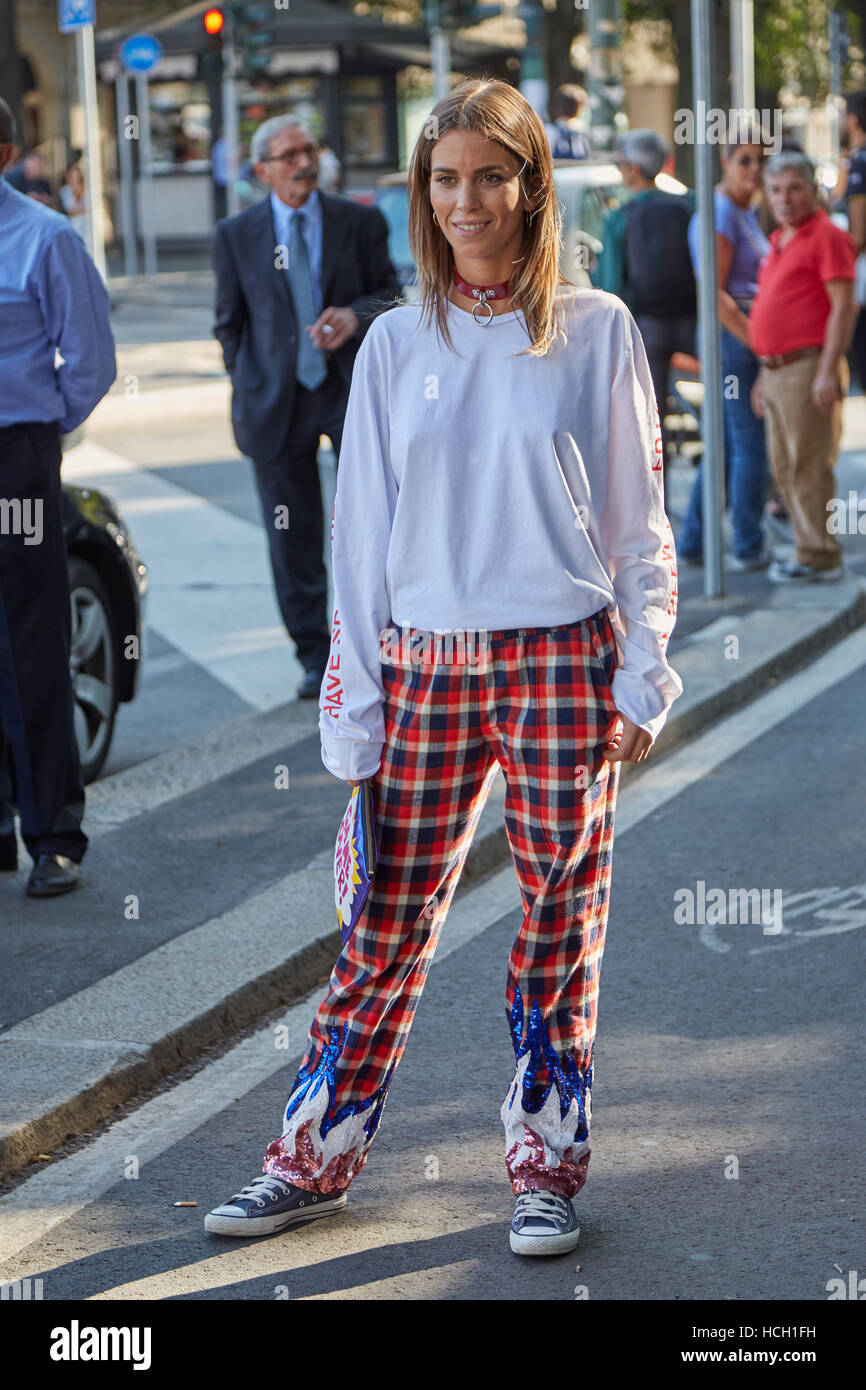 Woman with red and black checkered trousers before Jil Sander fashion show, Milan Fashion Week street style on September 2016. Stock Photo
