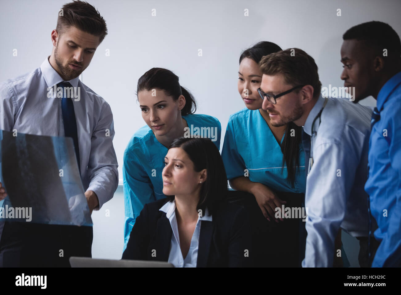 Medical team examining an x-ray report Stock Photo - Alamy