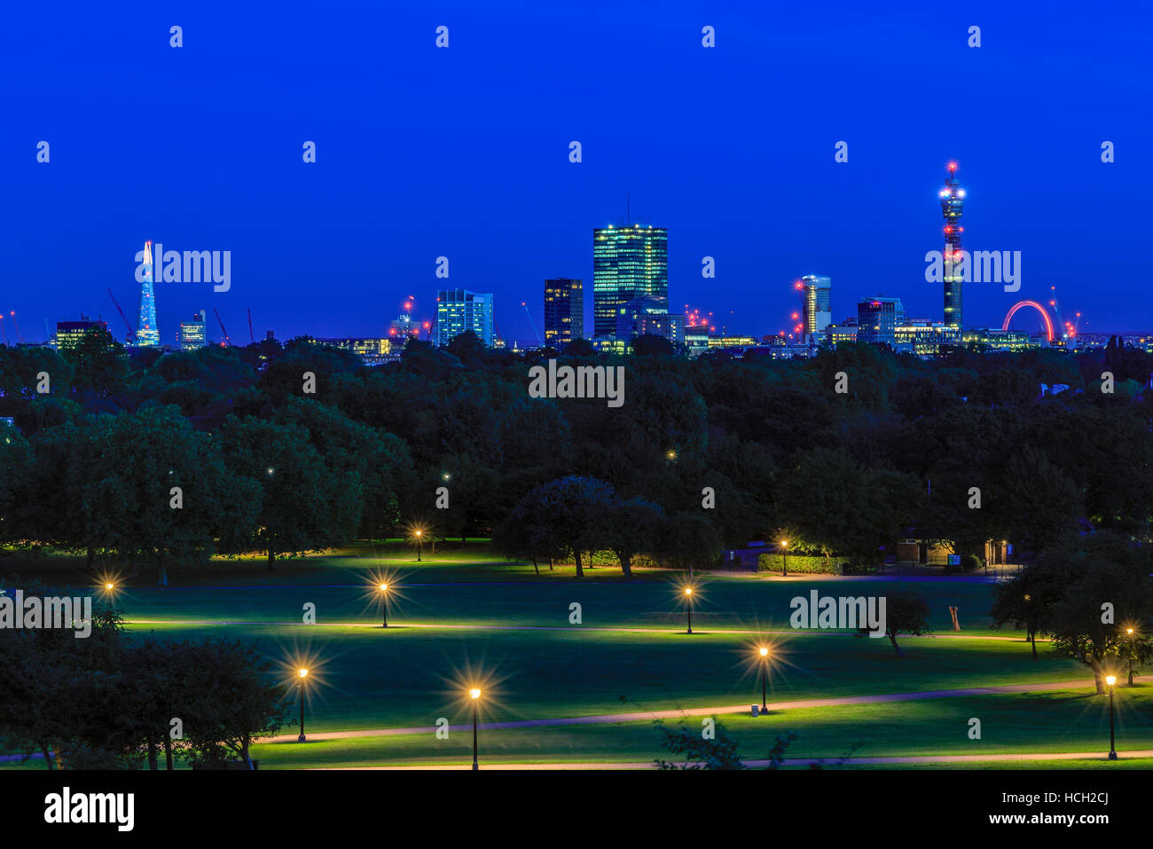 Illuminated London cityscape seen from Primrose Hill at night Stock Photo