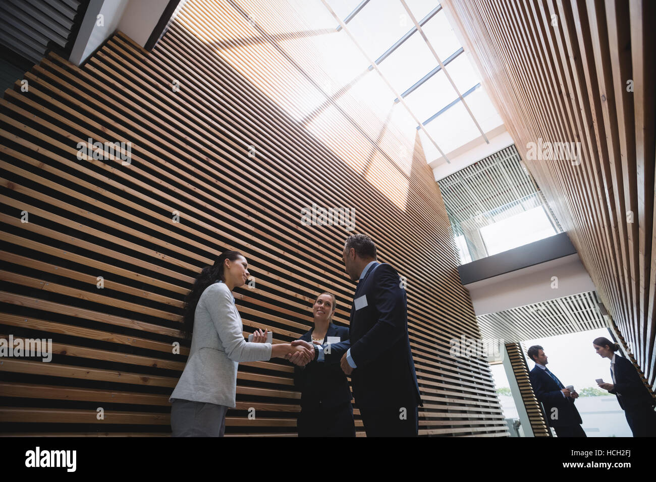 Businesspeople having a discussion and shaking hands during breaktime Stock Photo