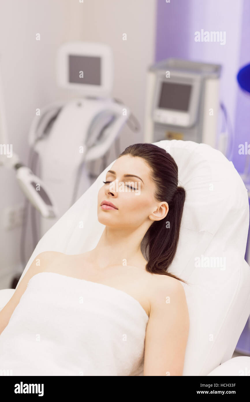 Female patient lying on dermatology chair Stock Photo