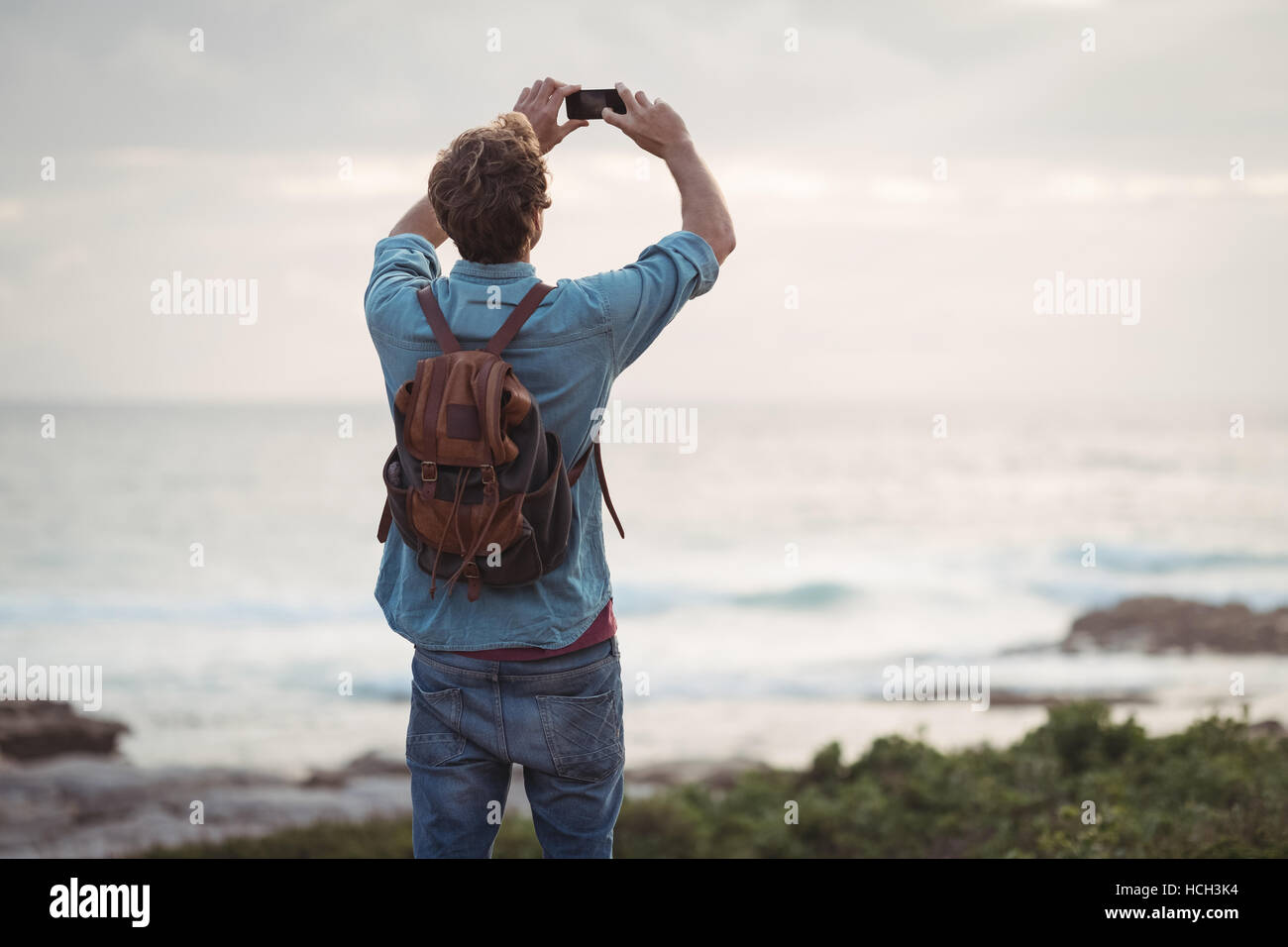 Man photographing using mobile phone Stock Photo
