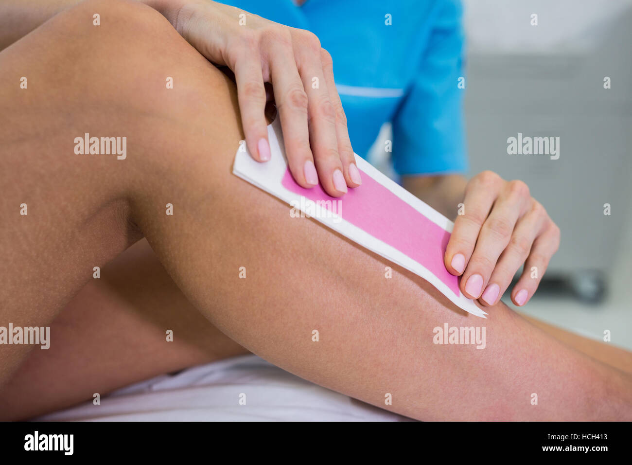 Woman getting her leg hair removed Stock Photo