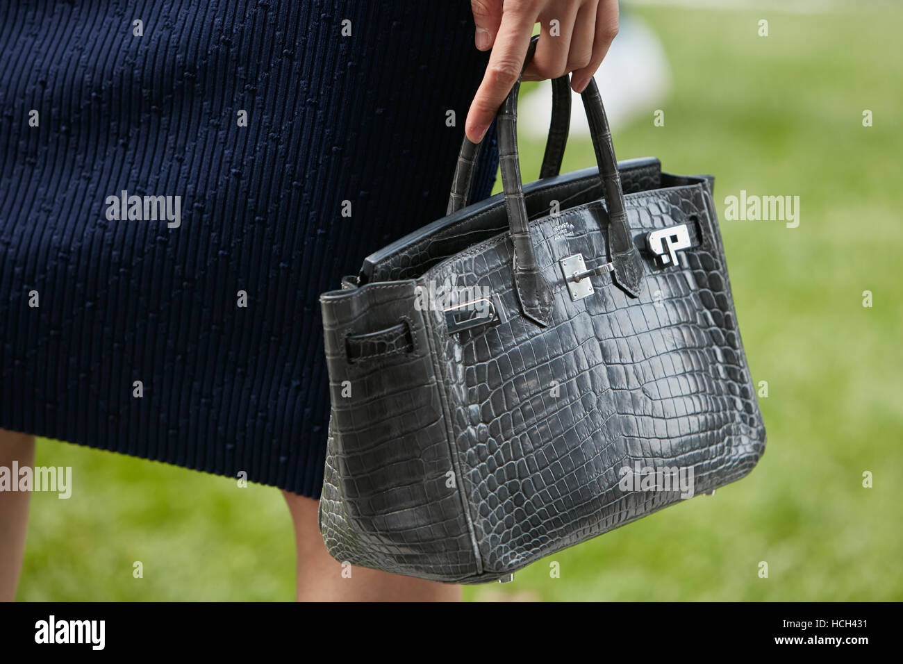 Woman with gray crocodile Hermes bag before Giorgio Armani fashion