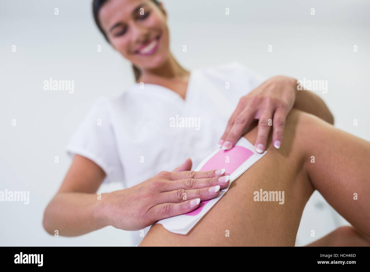 Woman getting her leg hair removed Stock Photo