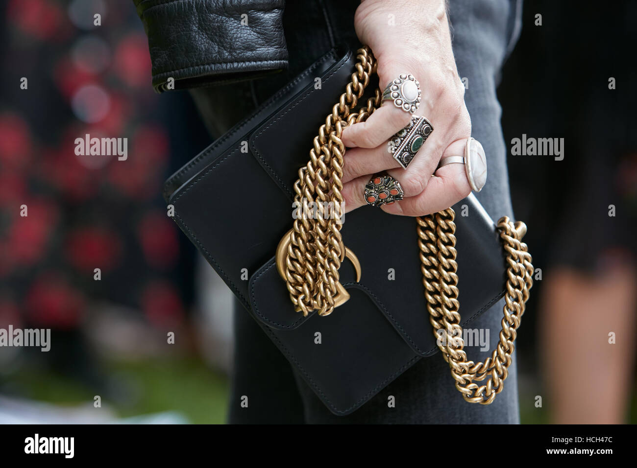 Man with White Shorts and Black Leather Bag before Gucci Fashion