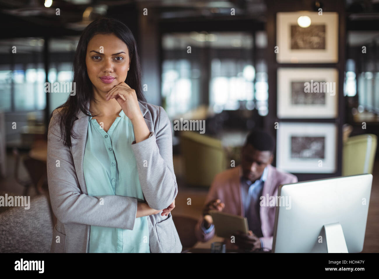 Businesswoman standing at her desk Stock Photo