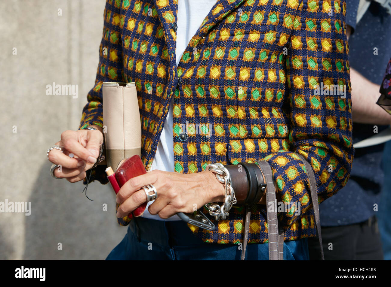 Woman with yellow, green, blue jacket pattern before Giamba fashion show, Milan Fashion Week street style on September 23, 2016 Stock Photo