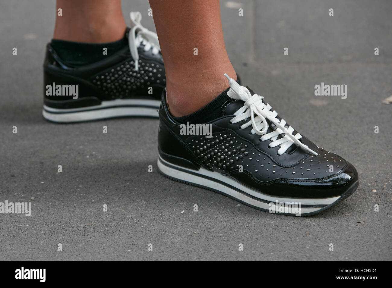 Woman with black Hogan shoes before fashion Tod's show, Milan Fashion Week  street style on September 23, 2016 in Milan Stock Photo - Alamy