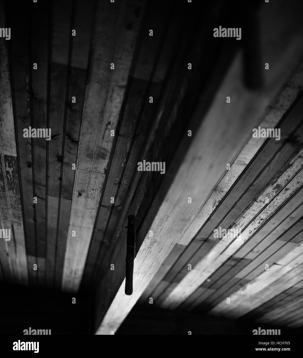 Ceiling built with wood flooring boards and a beam Stock Photo
