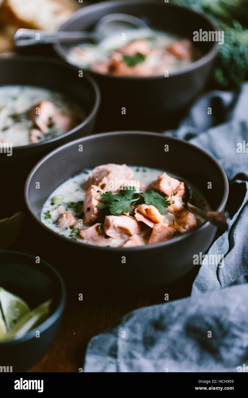 A bowl of salmon coconut chowder is photographed from the front view Stock Photo