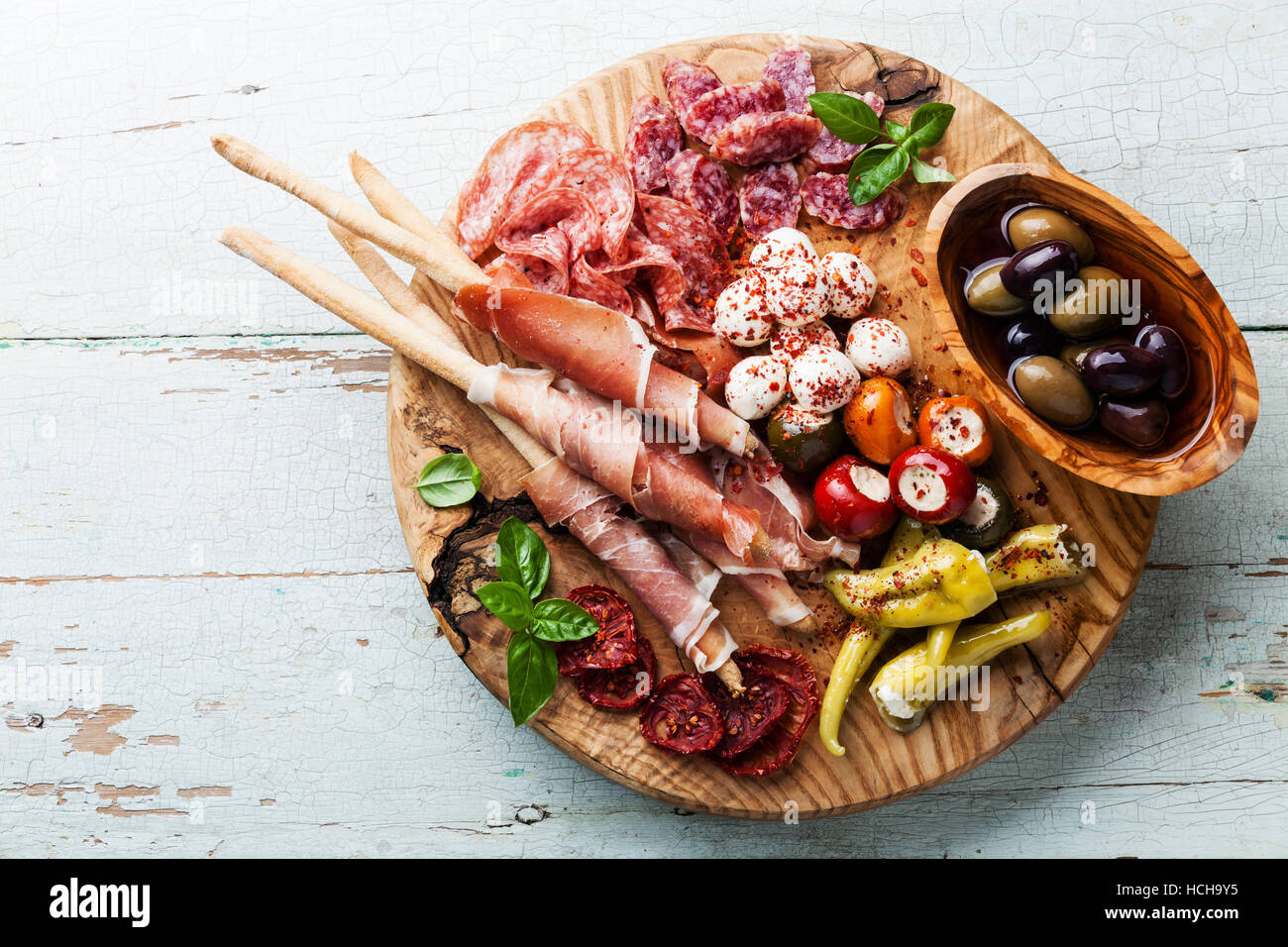 Antipasto Platter Cold meat plate with grissini bread sticks on wooden background Stock Photo