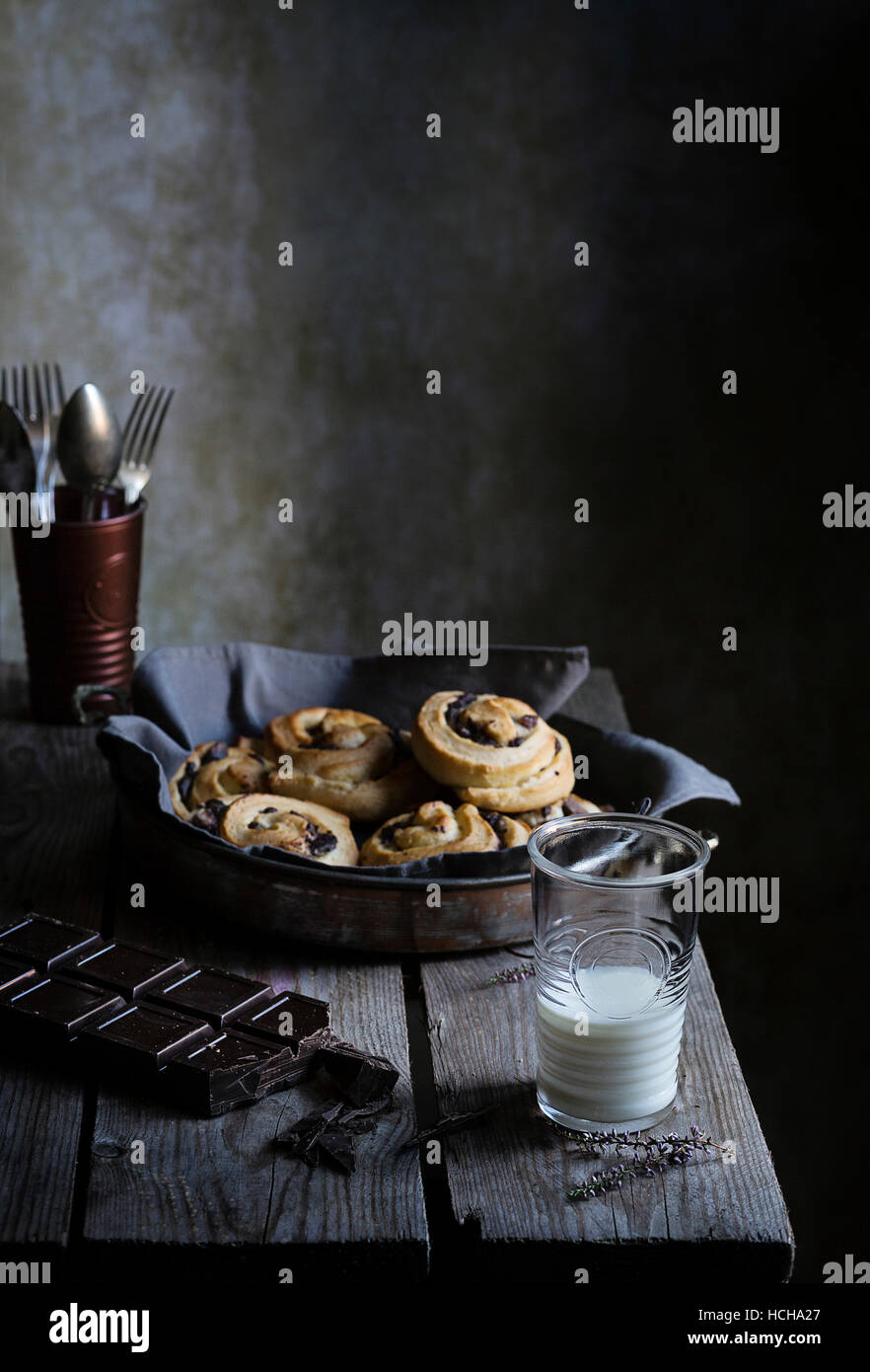 Homemade cinnamon rolls with a glass of milk on rustic table Stock ...