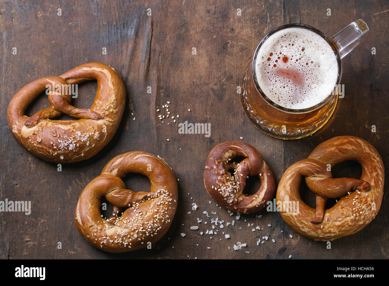 Glass of lager beer with traditional salted pretzels over old dark wooden background. Top view with space for text. Oktoberfest theme Stock Photo