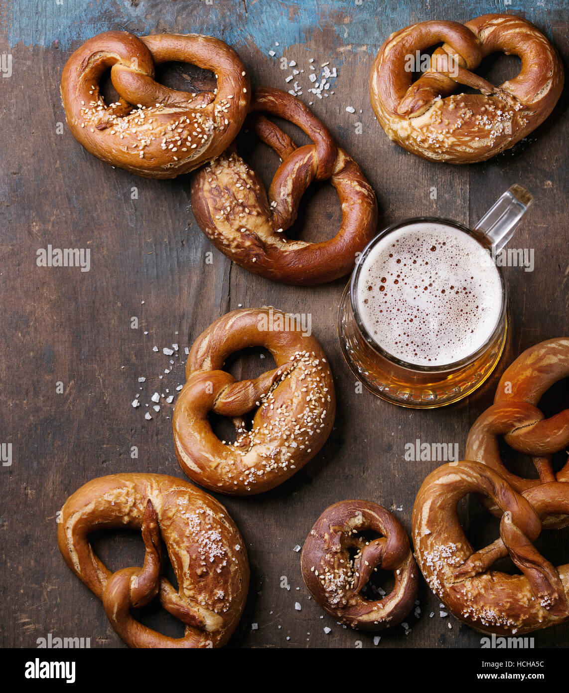Glass of lager beer with traditional salted pretzels over old dark wooden background. Top view with space for text. Oktoberfest theme Stock Photo
