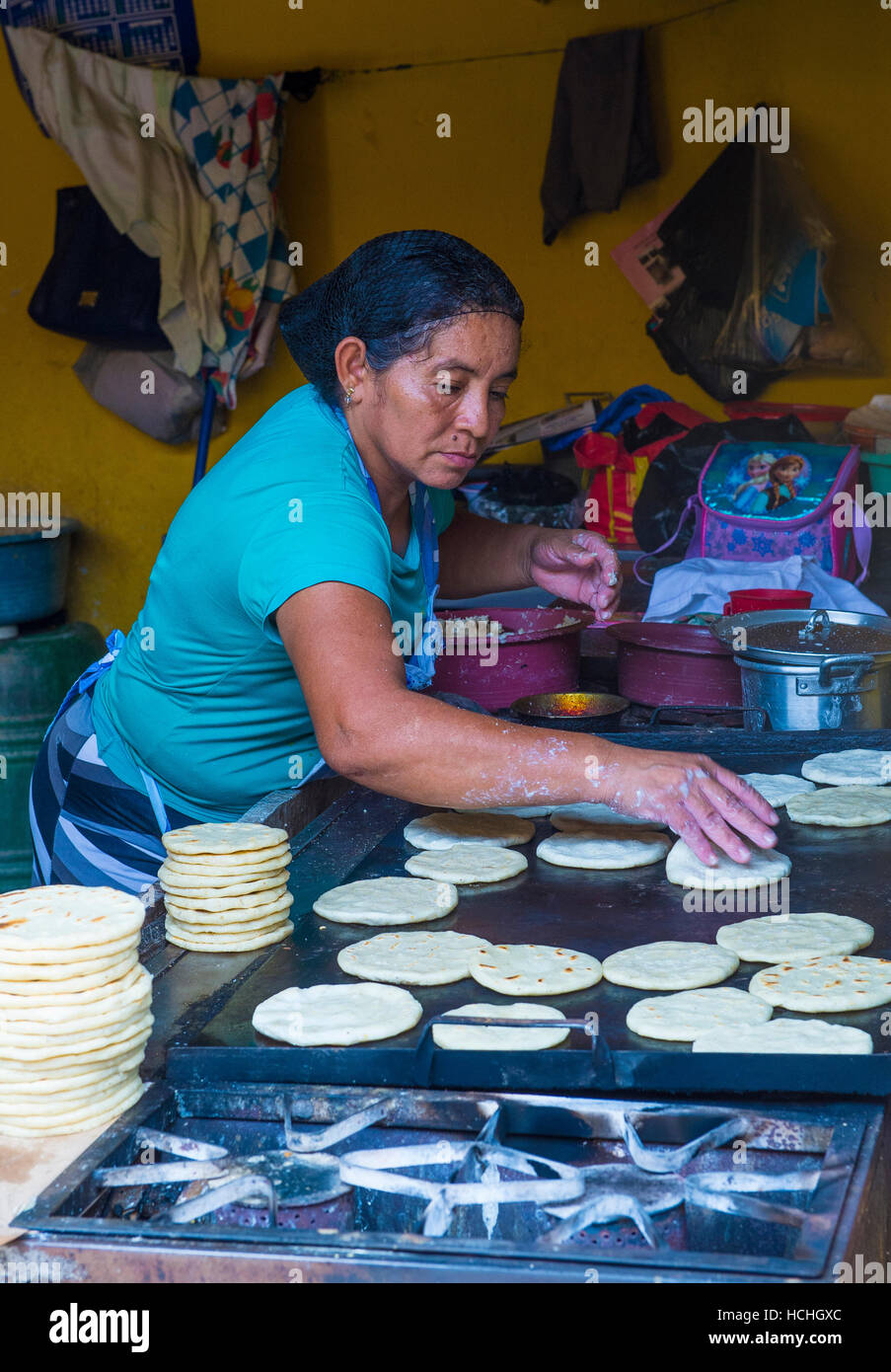 Salvadoran woman prepares Popusas in Suchitoto El Salvador. Popusa is a