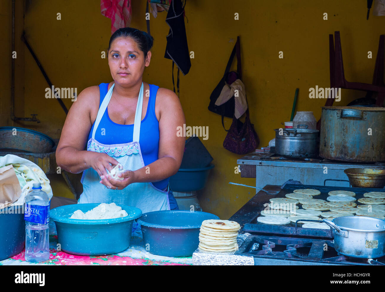 Salvadoran woman prepares Popusas in Suchitoto El Salvador. Popusa is a traditional Salvadoran dish made of corn tortilla Stock Photo