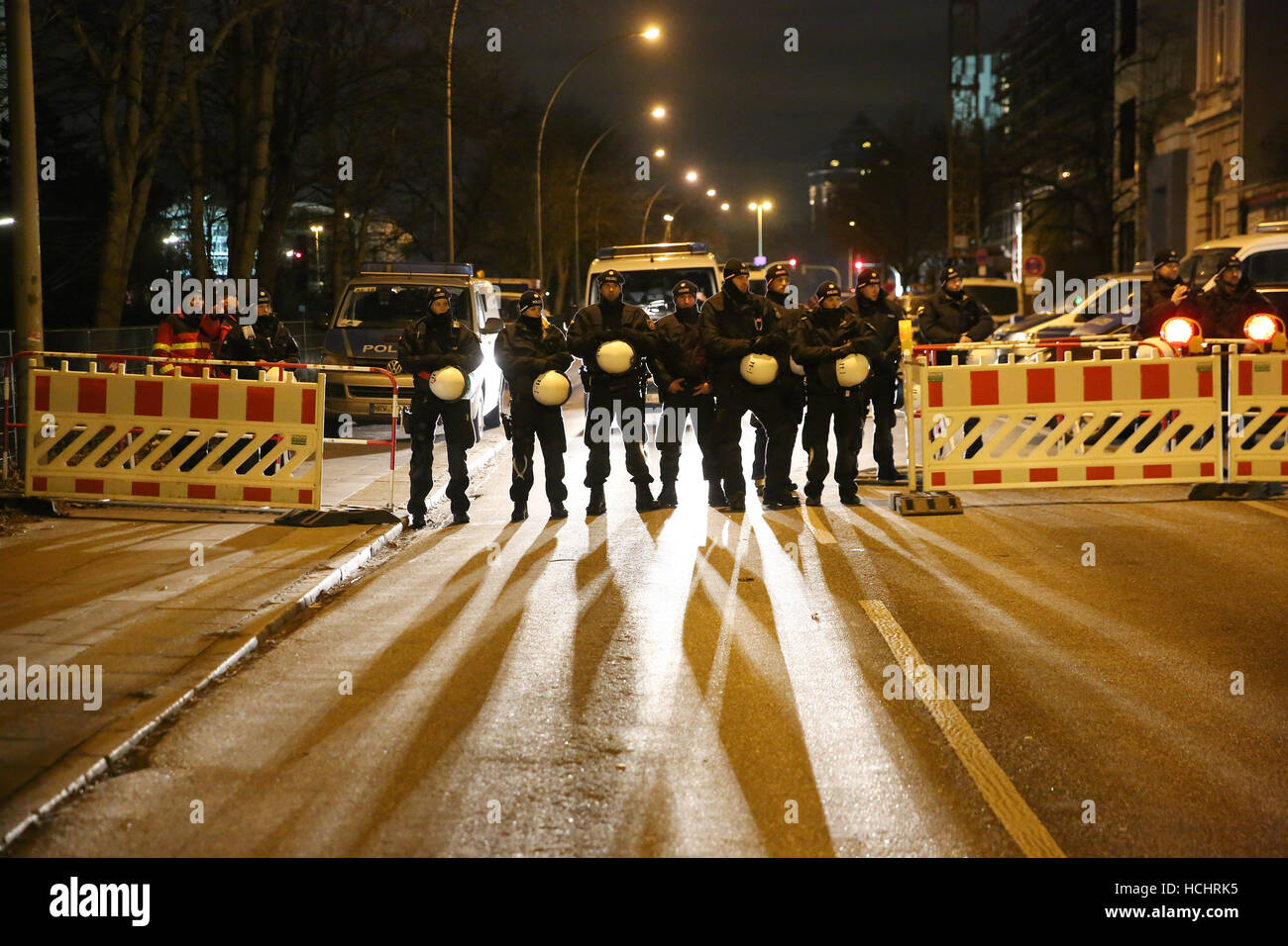 Hamburg, Germany. 8th Dec, 2016. Policemen block a road towards the fair grounds during a demonstration of left-wing groups against the OSCE Ministerial Council Meeting in Hamburg, Germany, 8 December 2016. The conference of the Organization for Security and Co-Operation in Europe (OSCE) takes place at the fair halls in Hamburg on 8 and 9 December. Photo: Bodo Marks/dpa/Alamy Live News Stock Photo