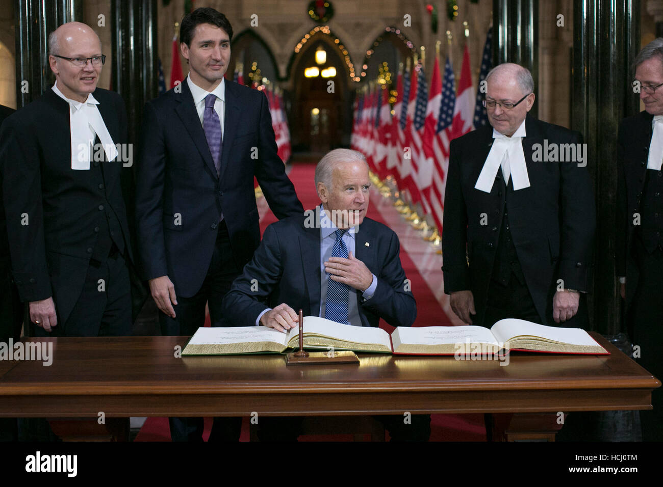 Ottawa, Canada. 9th Dec, 2016. U.S. Vice President Joe Biden (C) signs the official guestbook, joined by Canadian Prime Minister Justin Trudeau (2nd L), in Ottawa, Canada, on Dec. 9, 2016. Credit:  David Kawai/Xinhua/Alamy Live News Stock Photo