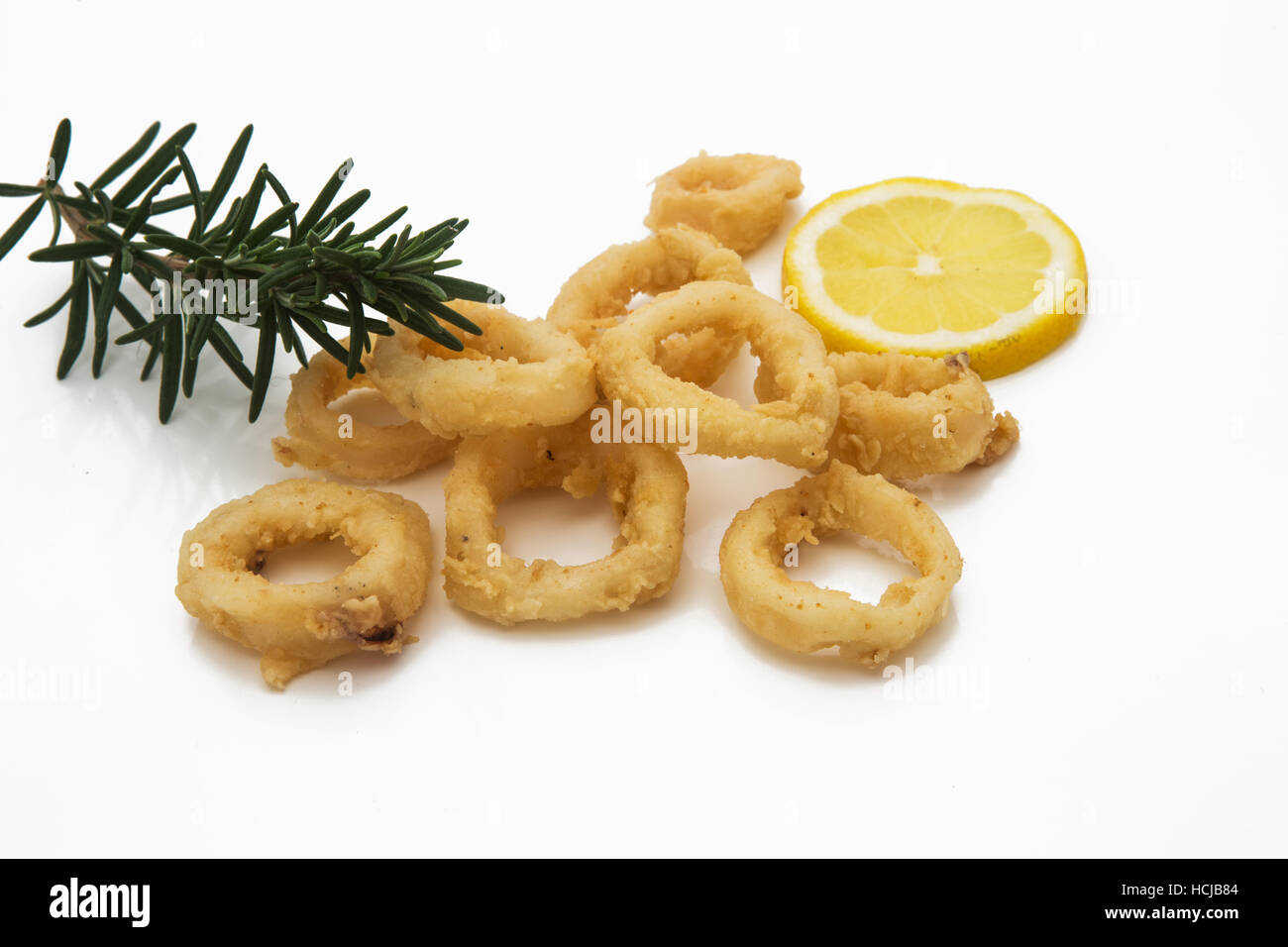 Calamari ring OR Fried squid ring with lemon and sauce - Italian food style isolated on white Stock Photo
