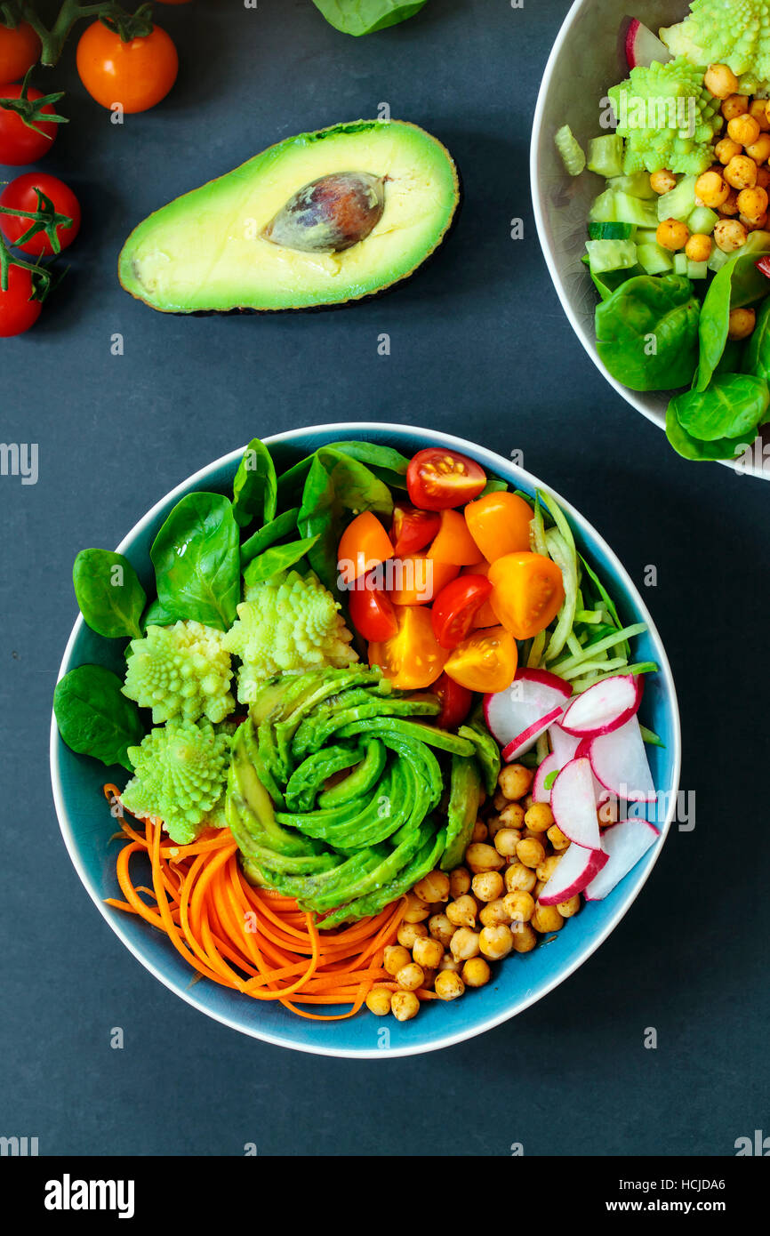Buddha vegetable bowl with avocado, romanesco cauliflower, carrots, chickpeas, tomatoes and radishes Stock Photo