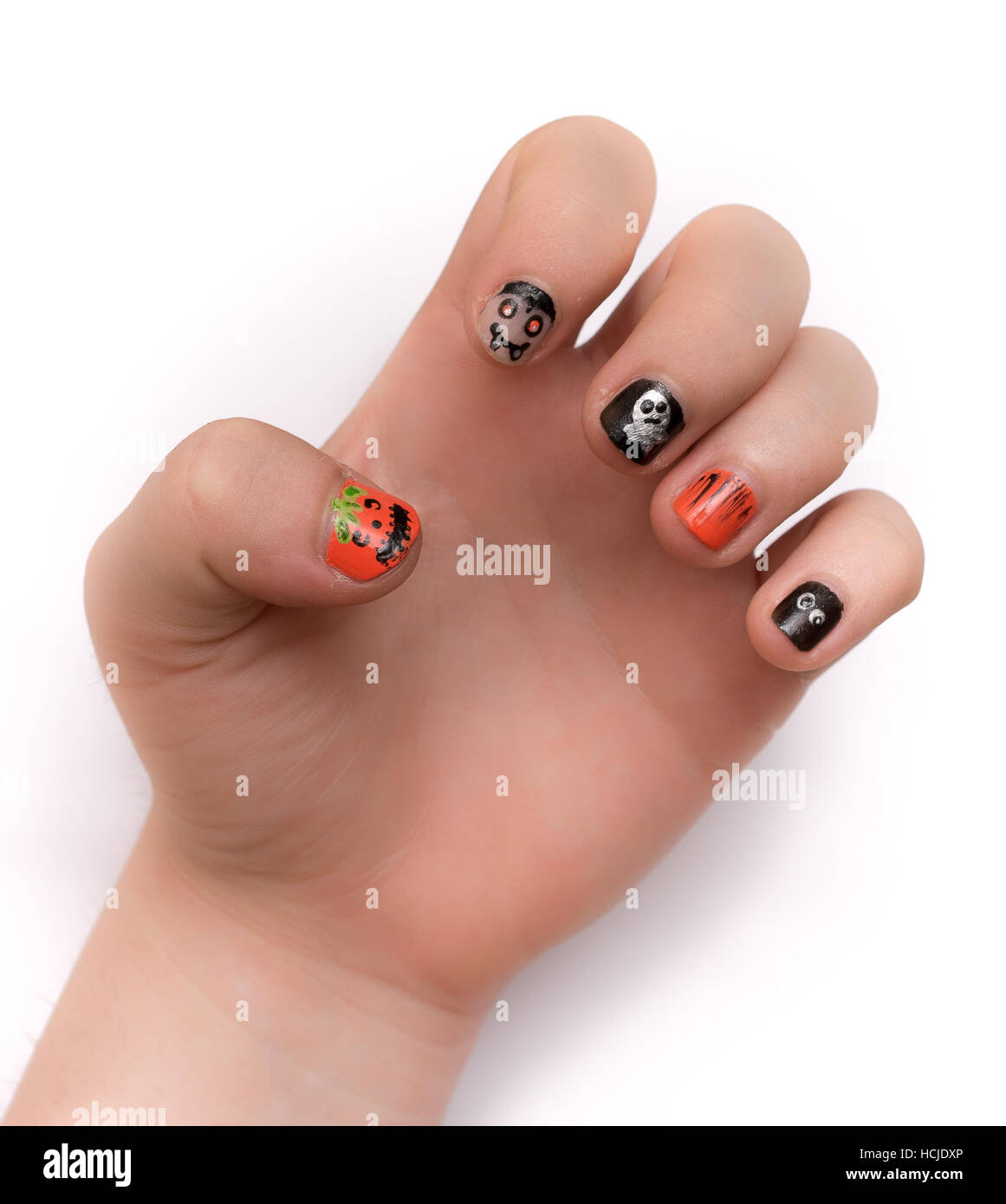 Young lady's fingernails painted artistically with Halloween icons and symbols, isolated on white Stock Photo