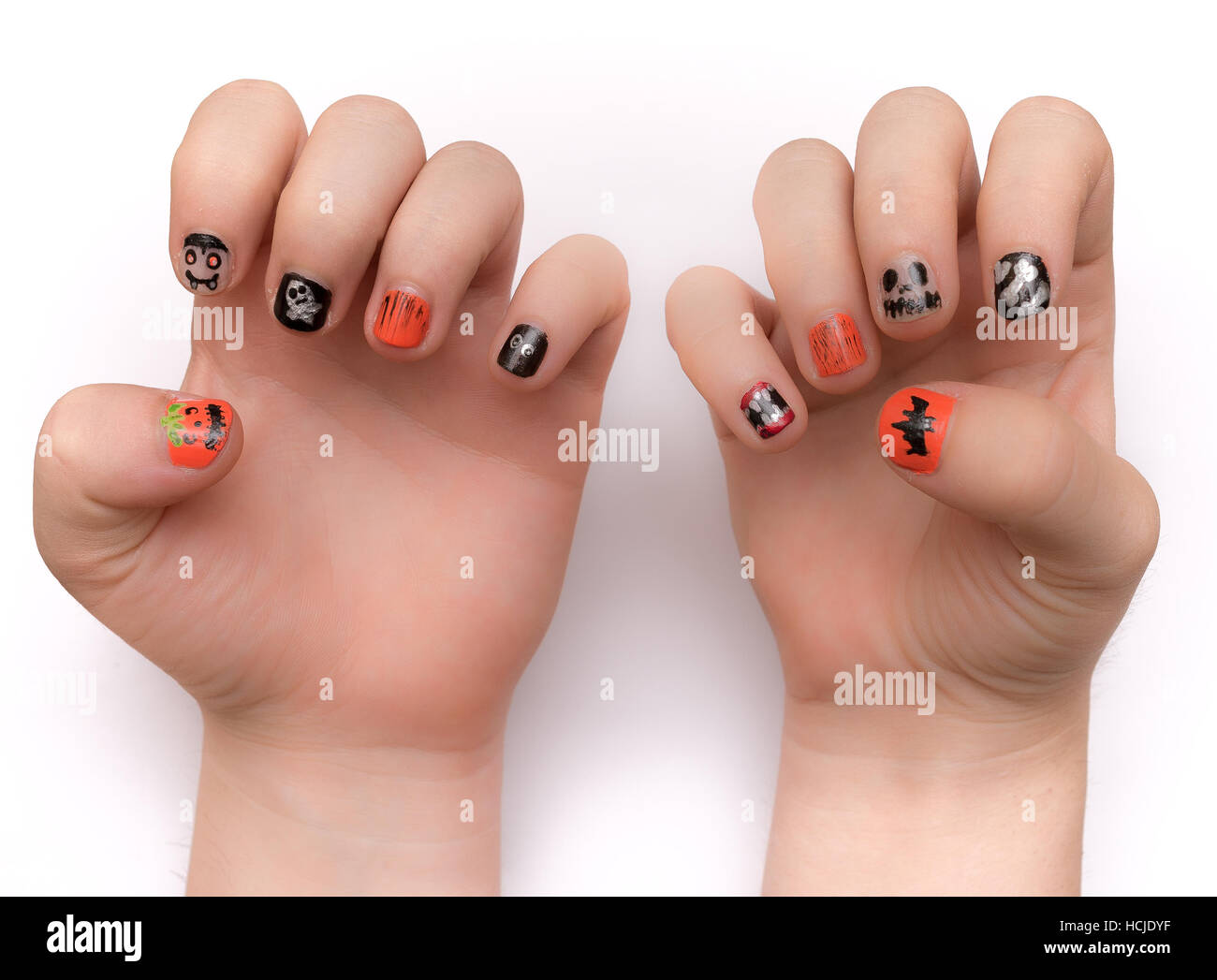 Young lady's fingernails painted artistically with Halloween icons and symbols, isolated on white Stock Photo