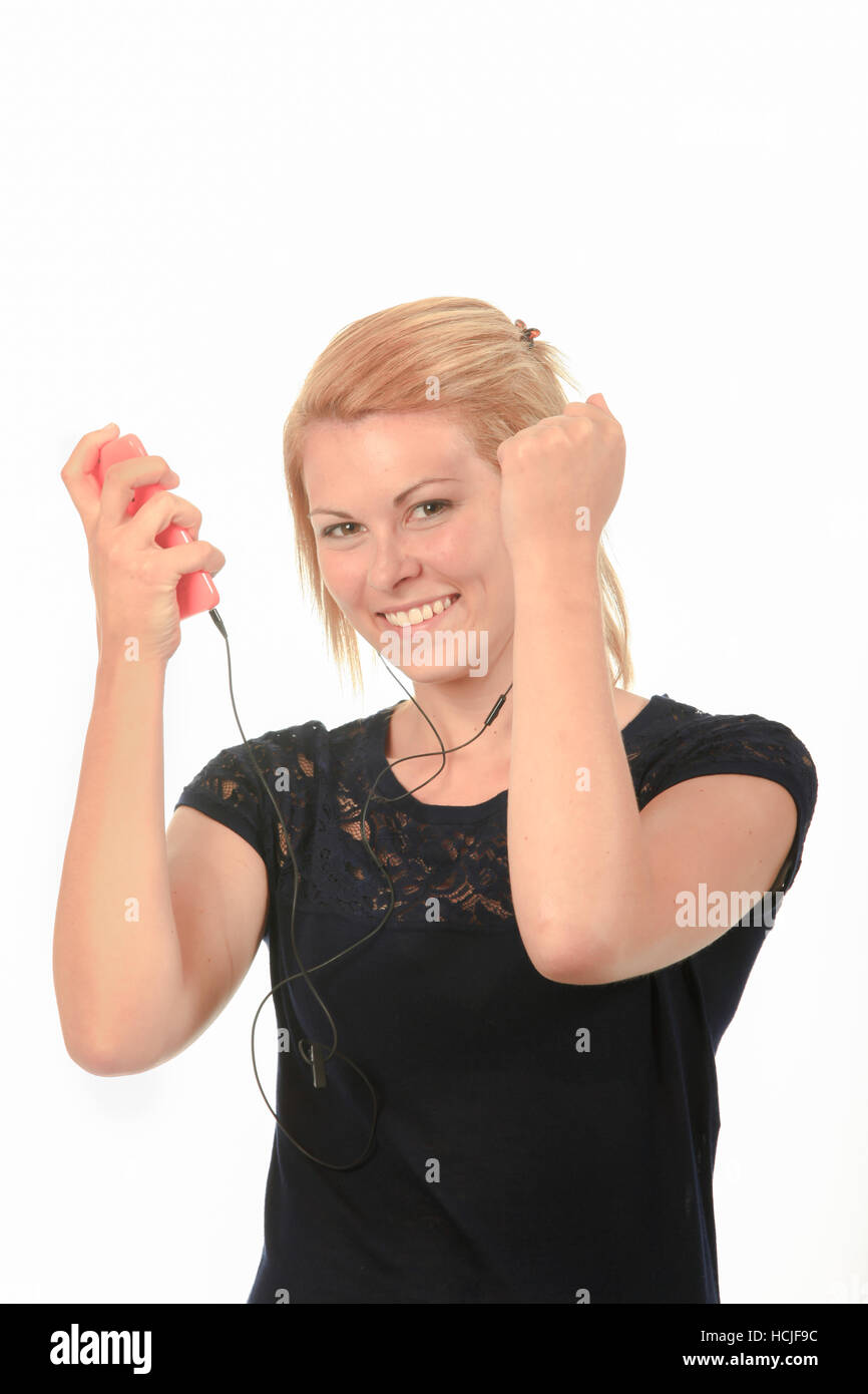 Happy young woman listening to music through headphones Stock Photo - Alamy