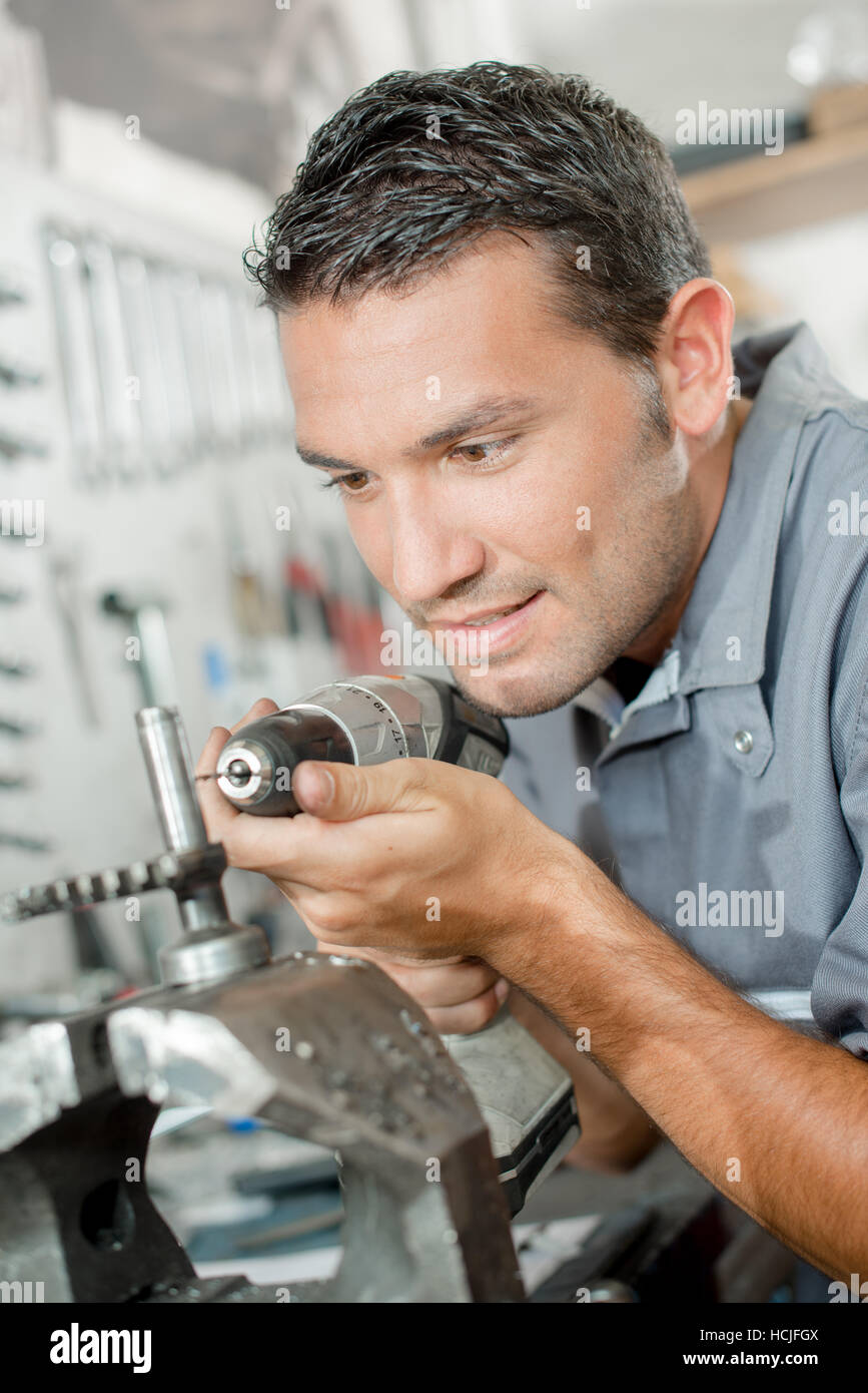 Mechanic using drill Stock Photo Alamy