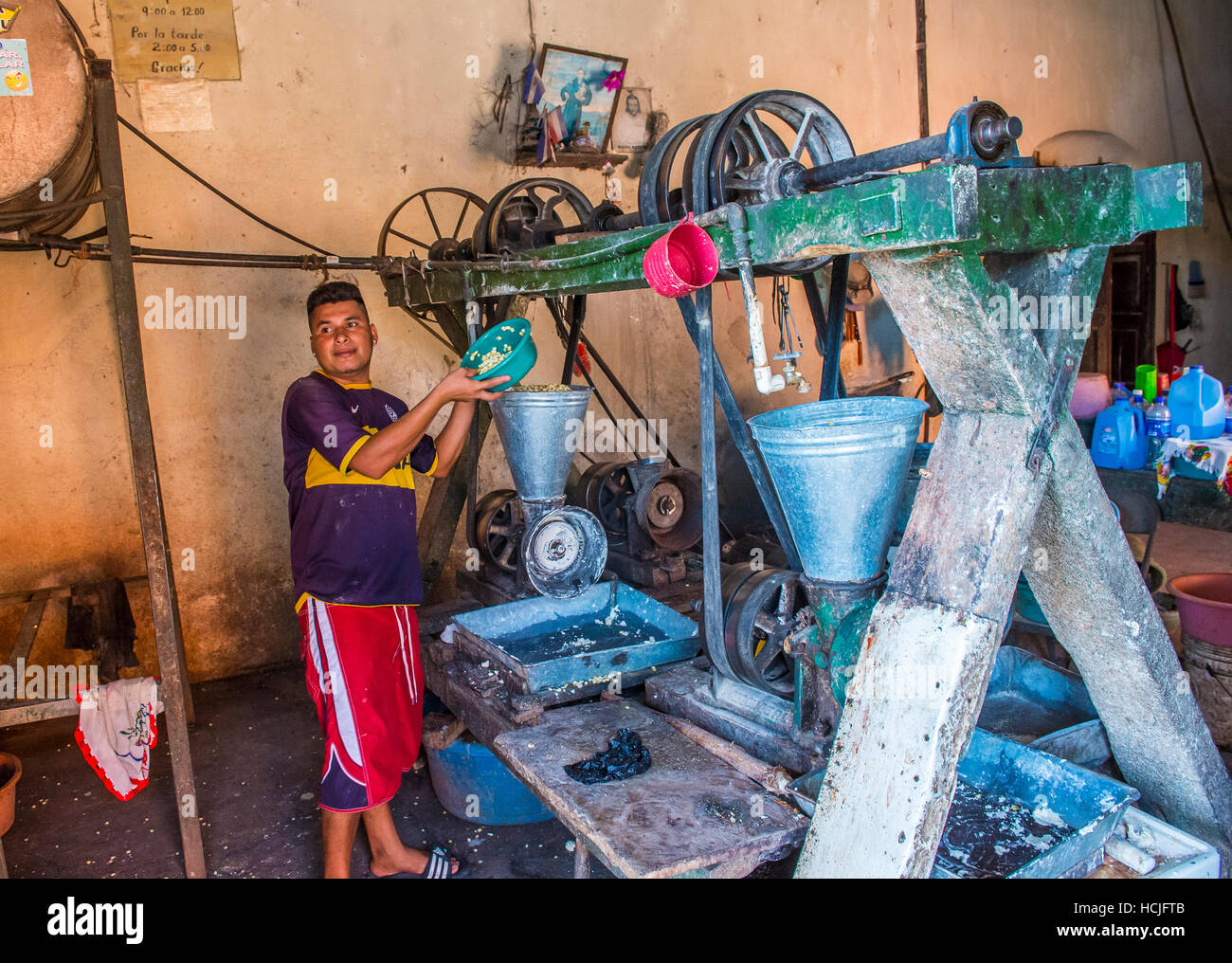 Salvadoran man work at a Corn tortilla dough factory in Suchitoto El Salvador. Corn has been a staple food in Central American cultures since pre-Colu Stock Photo