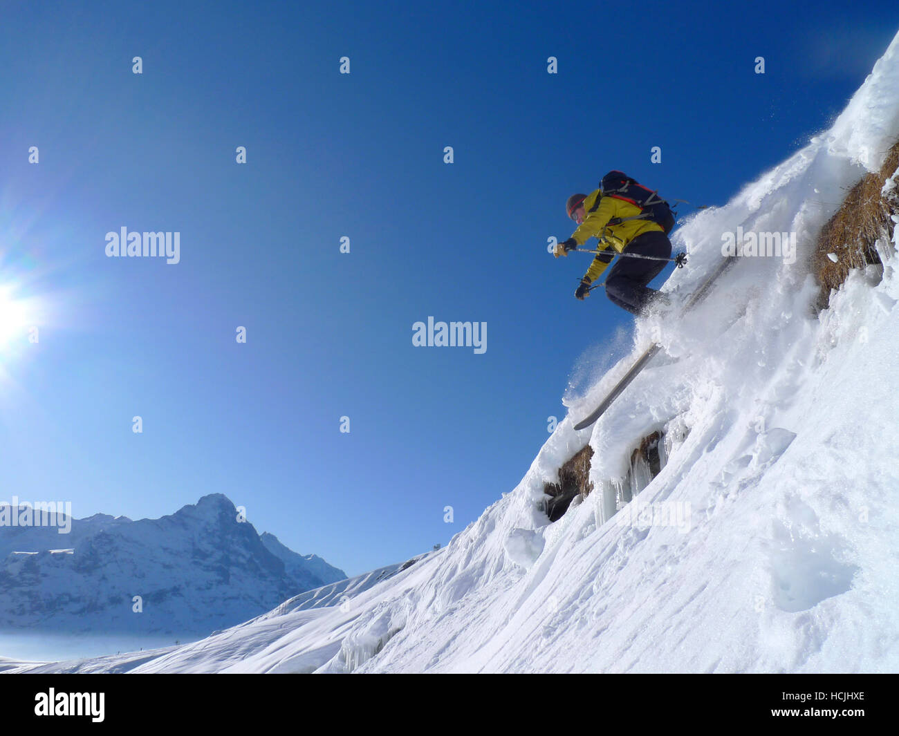 Skier Thomas Greenall is skiing down a slope in the ski area of Grindelwald in the Swiss Bernese Oberland. The mountain in the background is the famous Eiger. Stock Photo