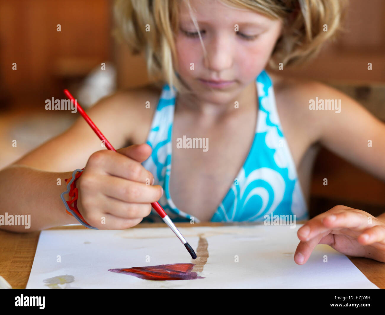 A young girl paints with watercolors. Stock Photo
