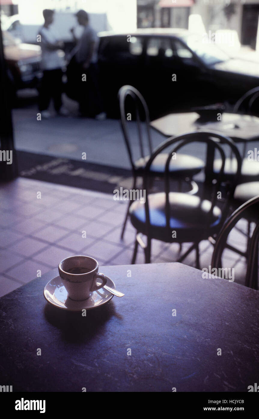 A fresh espresso in a traditional cup sits on a table in a cafe in the culturally rich North End, a neighborhood known as Boston's Little Italy. Stock Photo