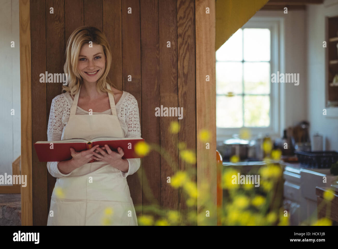 Portrait of beautiful woman holding recipe book Stock Photo