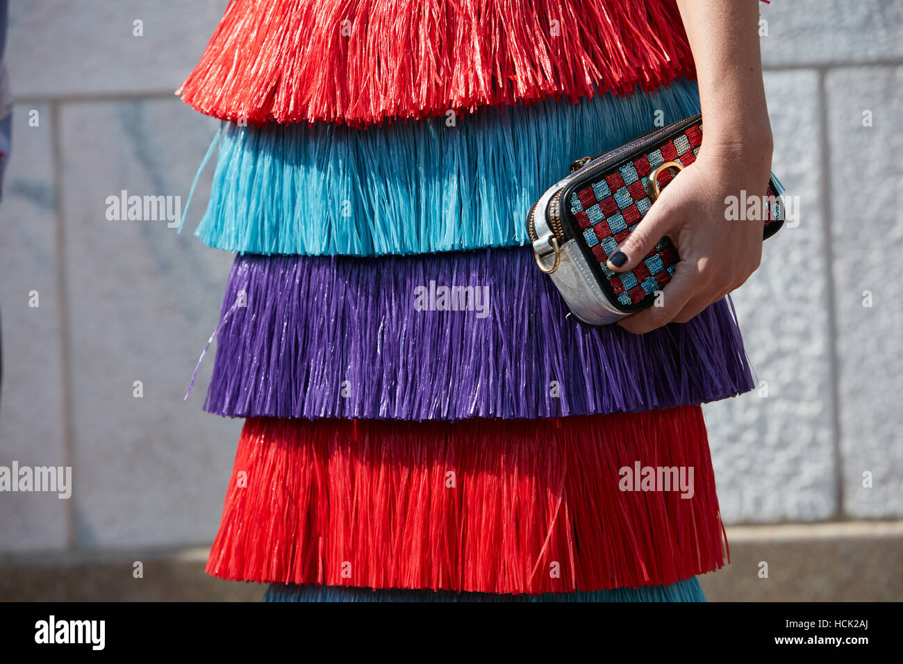 Woman with colorful skirt with fringes before Stella Jean fashion show, Milan Fashion Week street style on September 25, 2016. Stock Photo